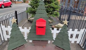 Wooden postbox and trees decoration.